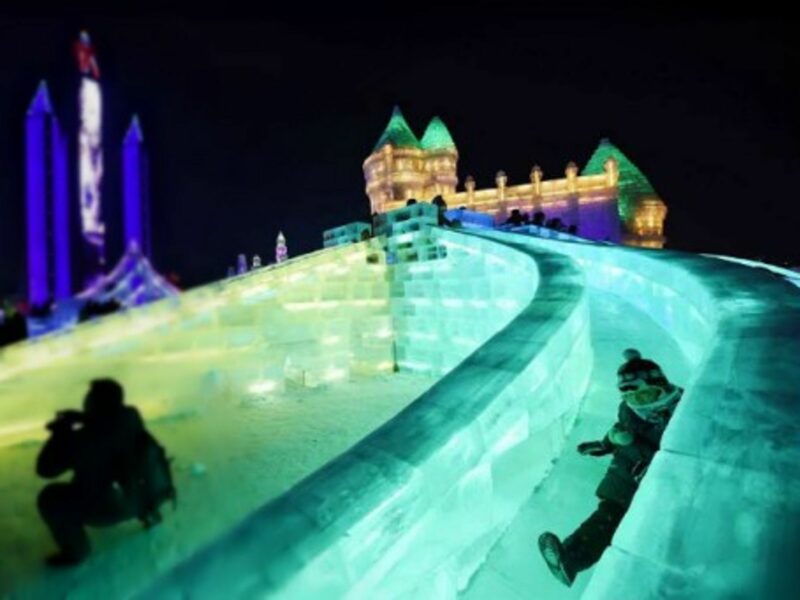 Having fun on ice slides Monday at Harbin's Ice and Snow World in northeastern China.