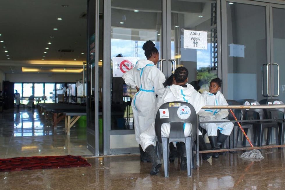 Health workers prepare at National Heroes Stadium, a temporary cholera treatment center in Lusaka, after cleaning for incoming patients.
