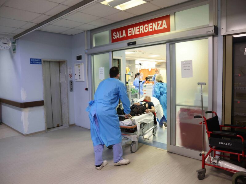 Health workers wearing overalls and protective masks at work in the intensive care unit of the hospital of Cremona