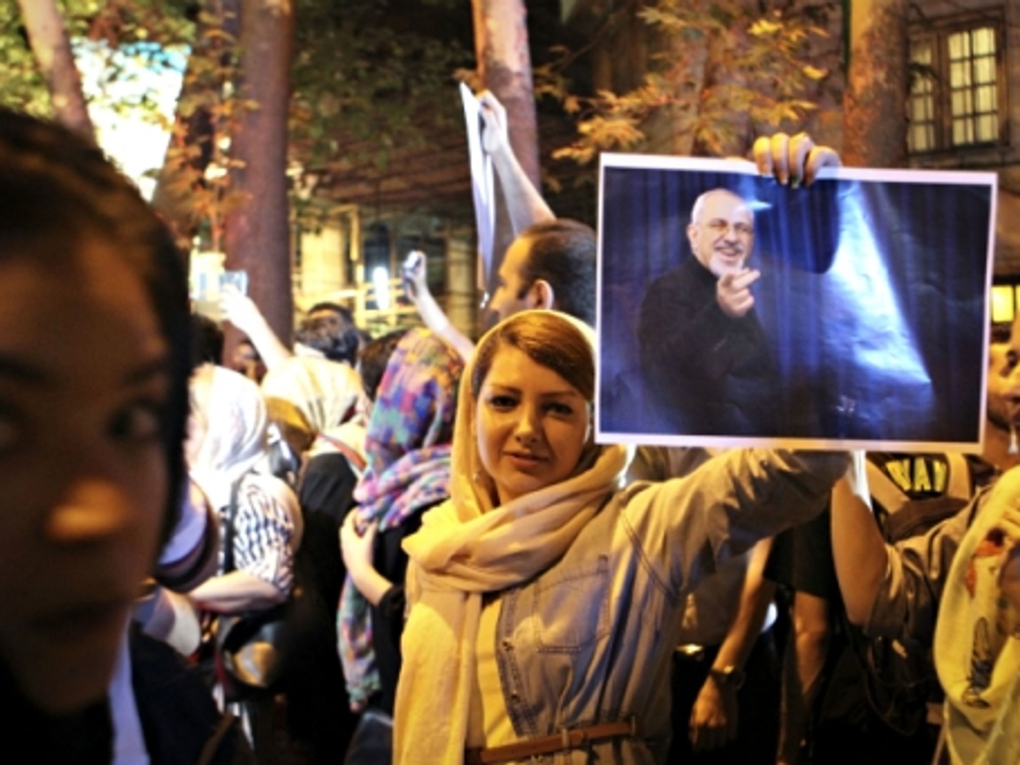 Holding a poster of Iranian Foreign Minister Mohammad-Javad Zarif to celebrate the nuclear agreement, in Tehran on July 14