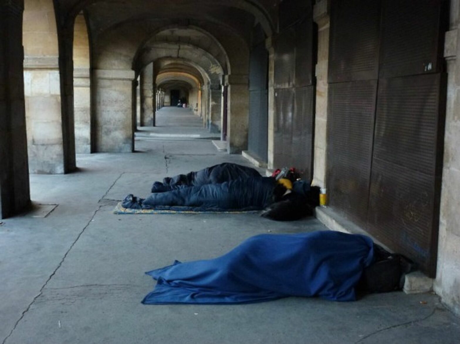 Homeless people sleeping near Places des Vosges in Paris