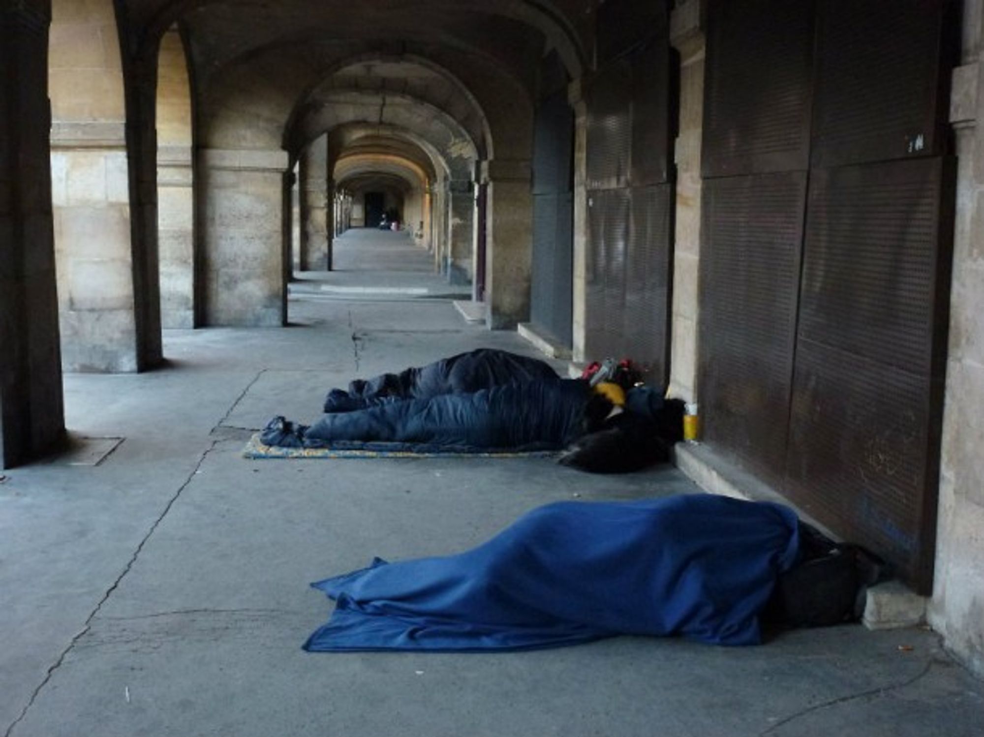 Homeless people sleeping near Places des Vosges in Paris