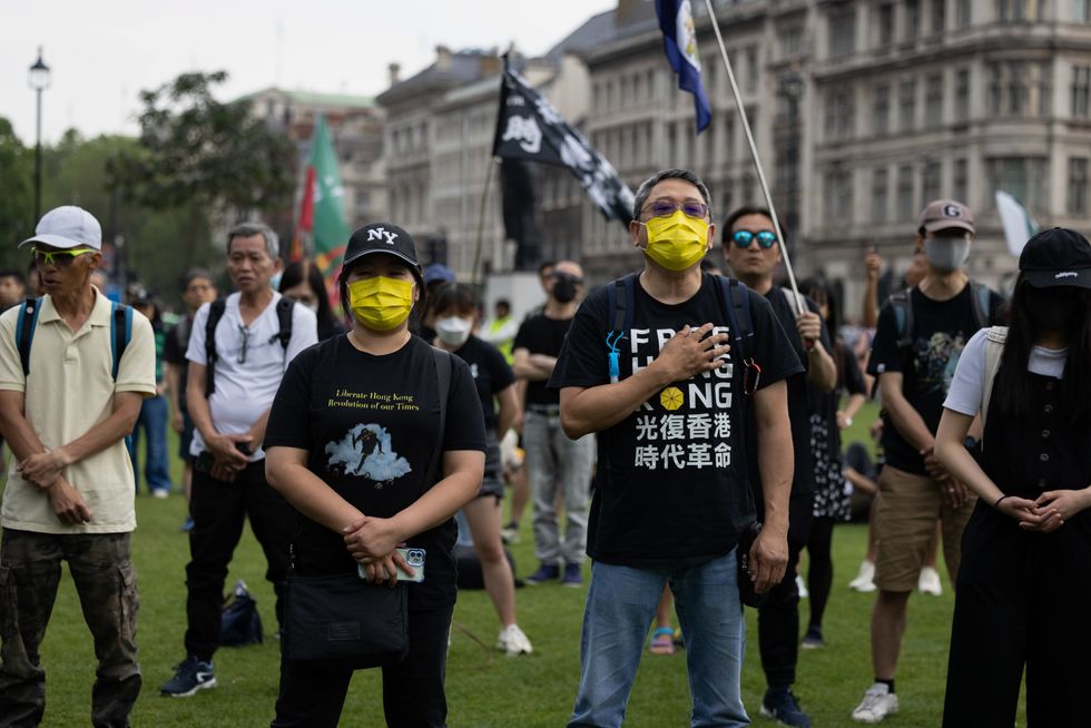 Hongkonger protesters sing while gathered at Parliament Square, London, England