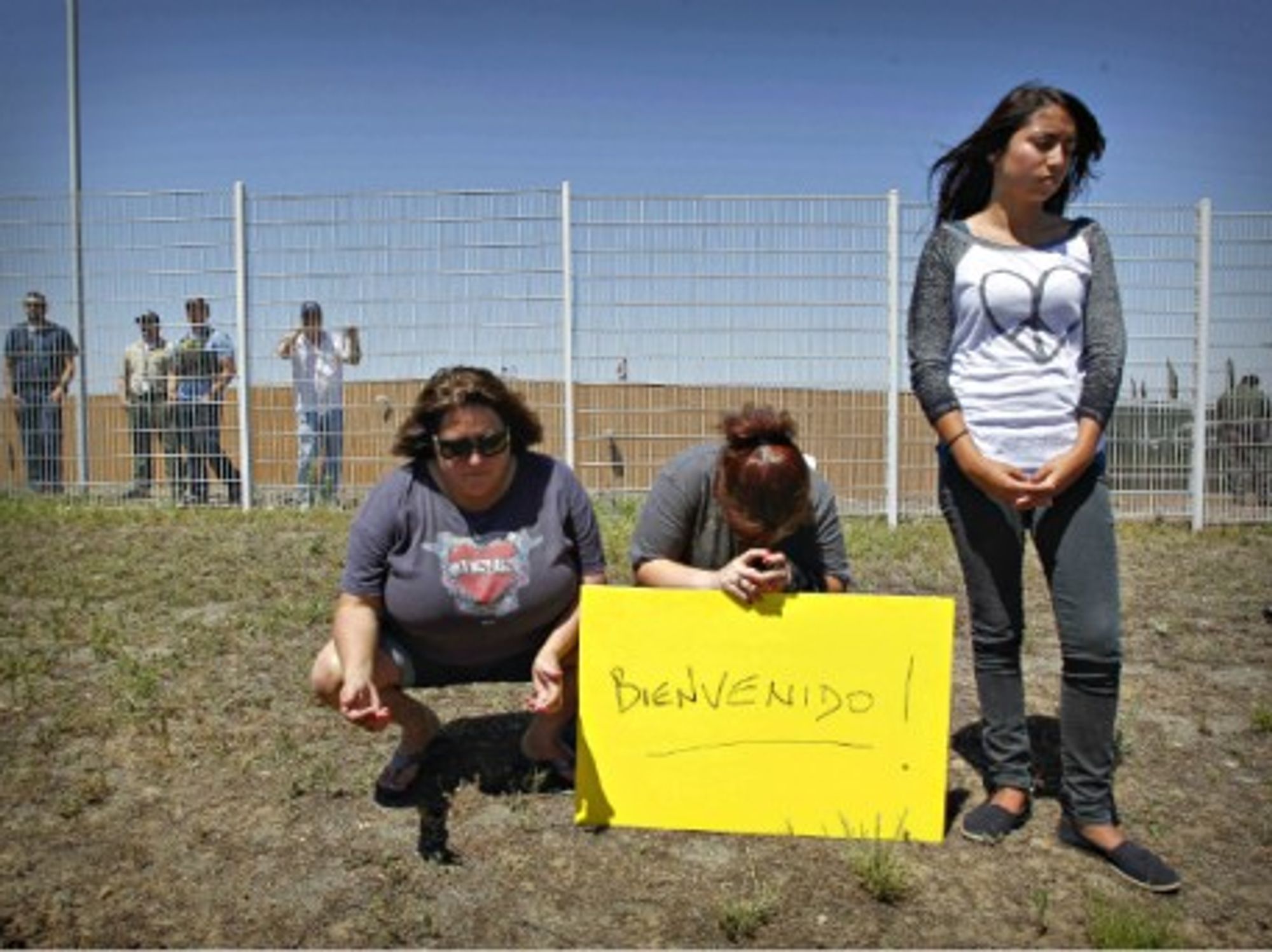 Human rights protesters pray for women and children stopped from entering the Border Patrol facility in Murrieta, CA, on July 1.