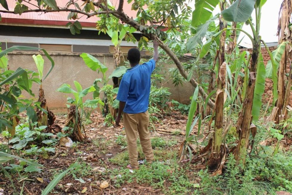 Iga, a construction worker whose last name and face are being withheld to protect his privacy, stands outside his home in Wakiso district, Uganda. Iga tested positive for HIV in 2015, but doesn’t take antiretroviral medication and says he feels fine.