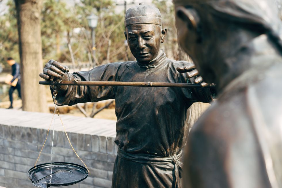 Image of a bronze statue of a man in Beijing, China.
