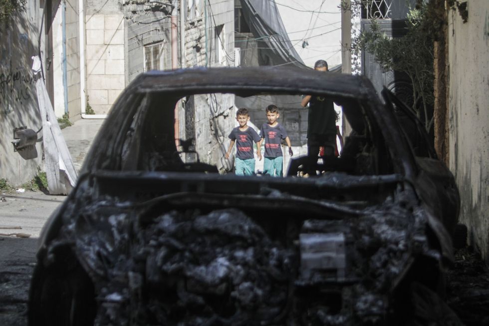 Image of a burnt and destroyed car in the Jenin refugee camp