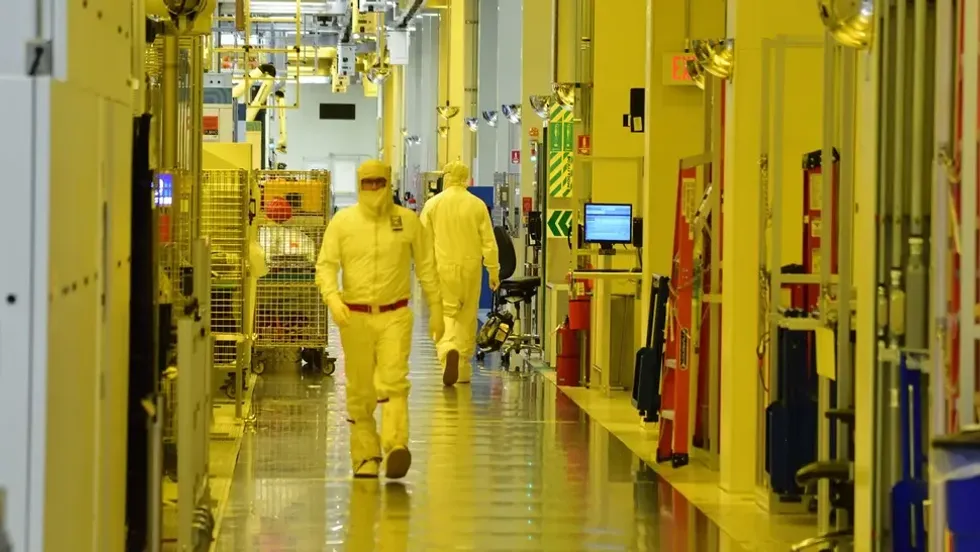image of a factory and 2 workers