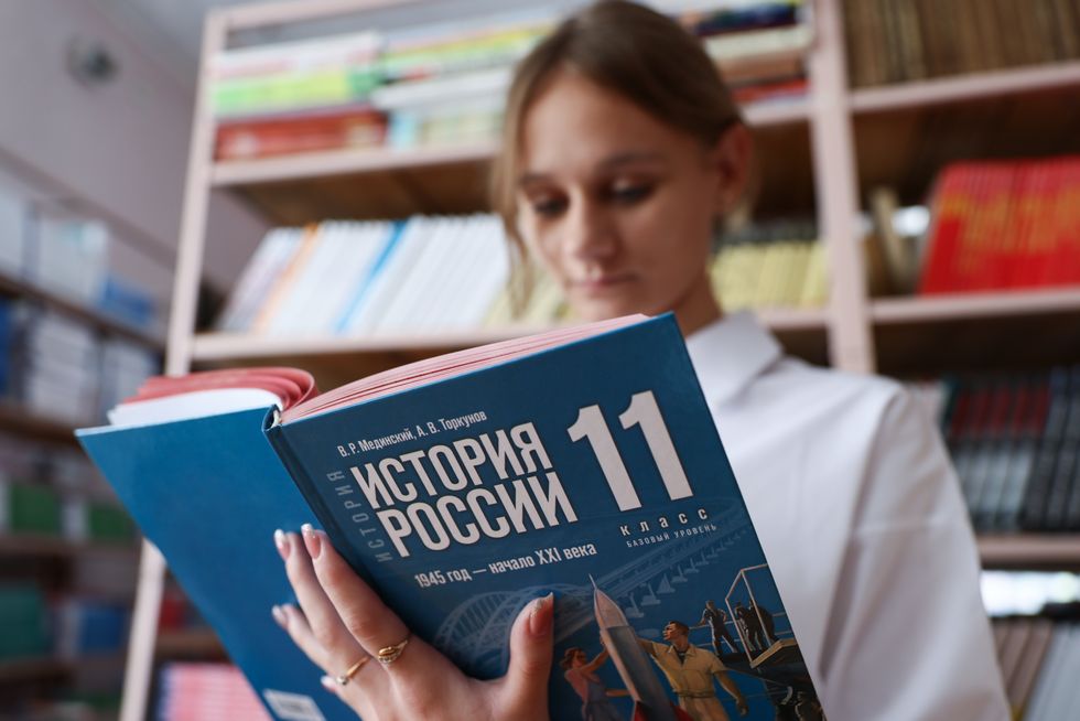 image of a girl reading a Russian history textbook