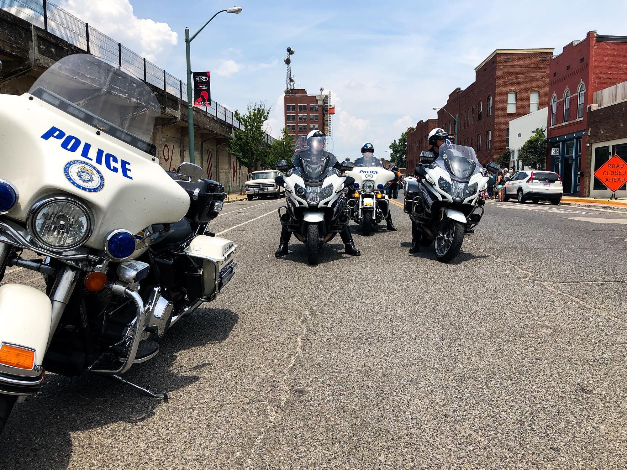 Image of a group of police officers, in uniform, on their motorbikes in the street.