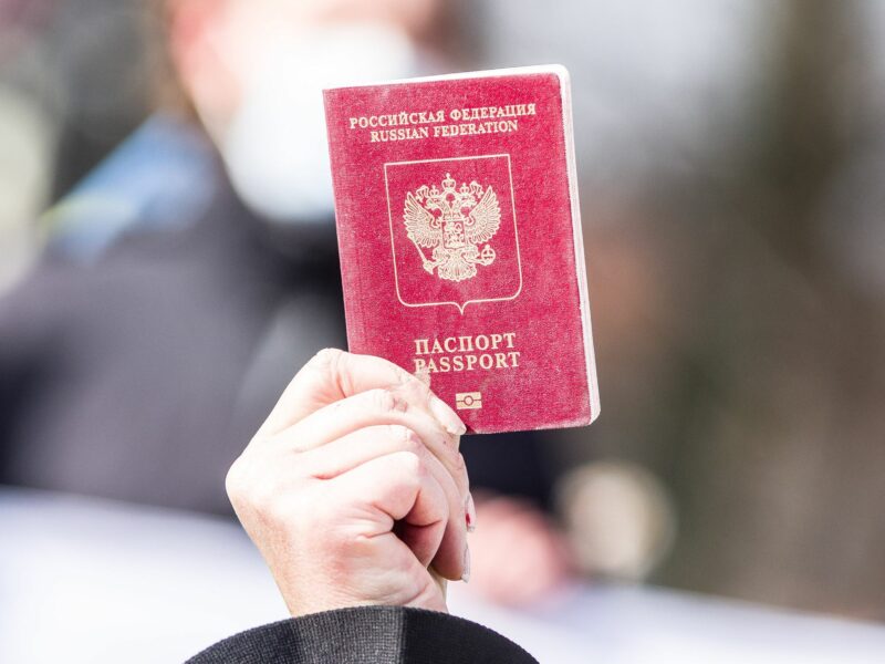 Image of a hand holding a red Russian passport.