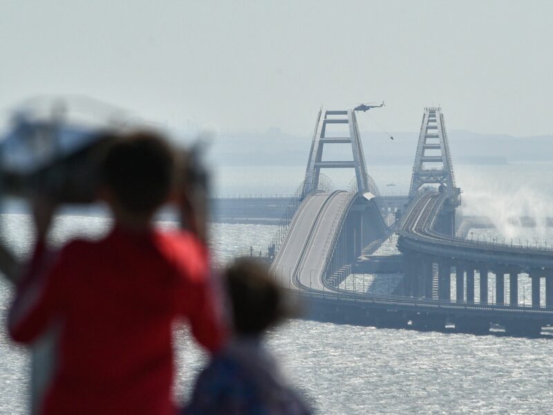 image of a helicopter extinguishing a fire on a bridge linking Crimea to mainland Russia.​