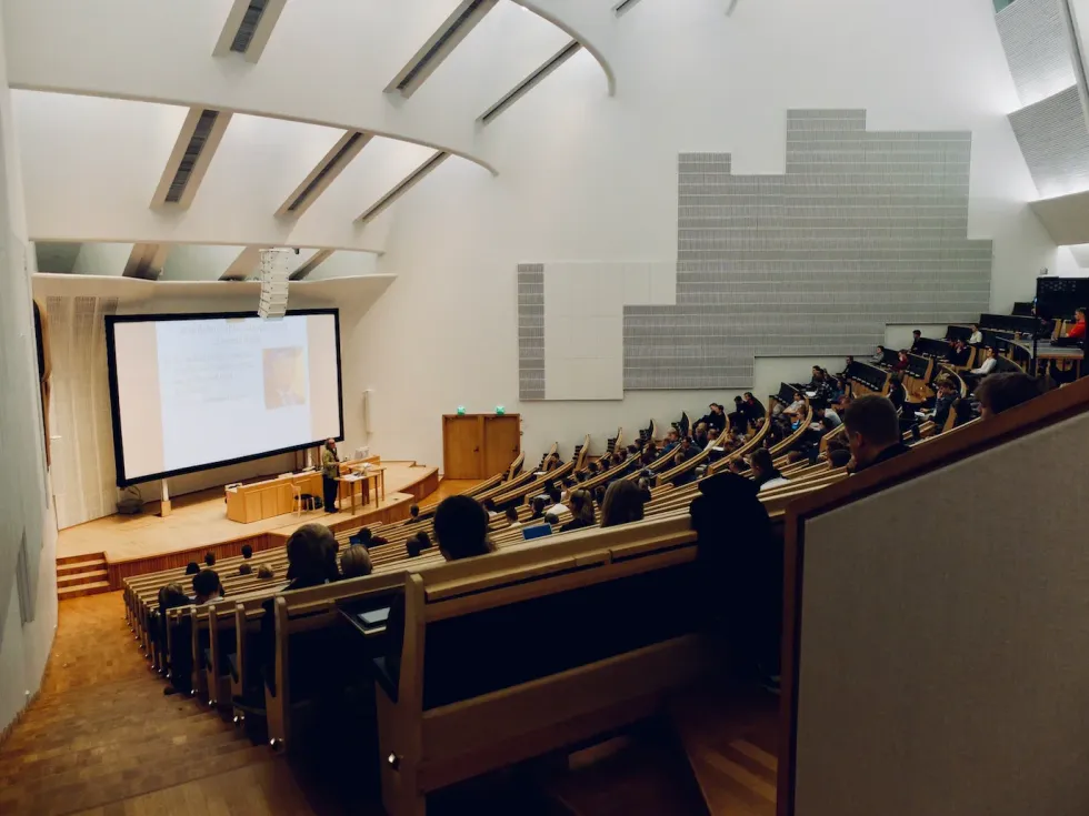 image of a lecture hall where students attend a class.