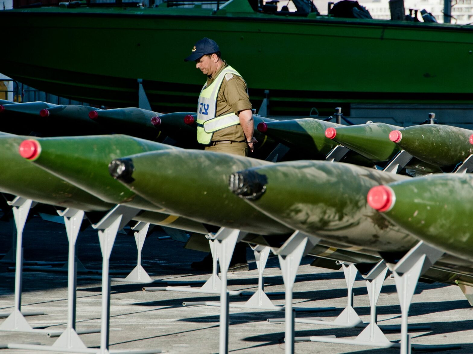 image of a man inspecting missiles