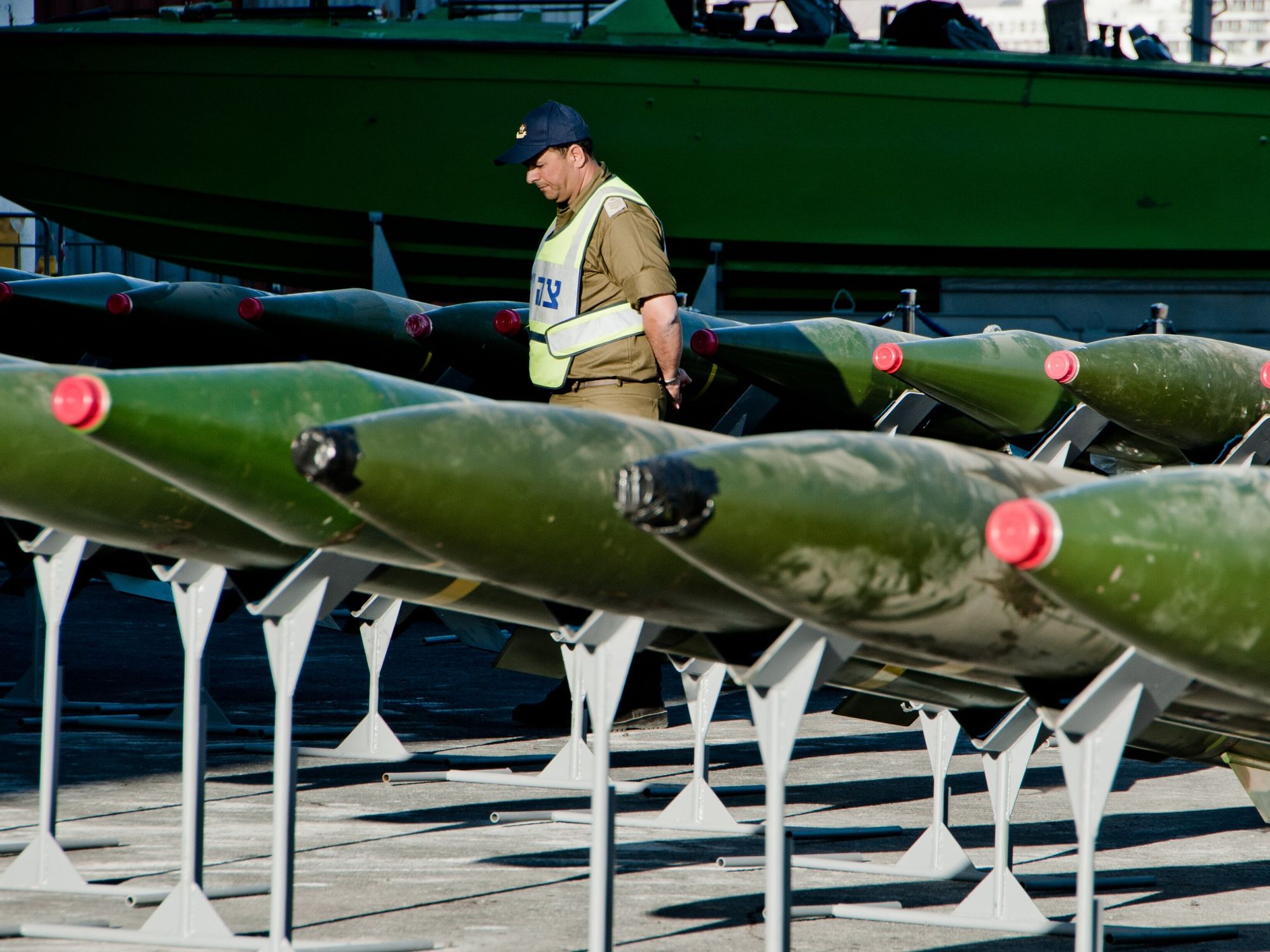 image of a man inspecting missiles
