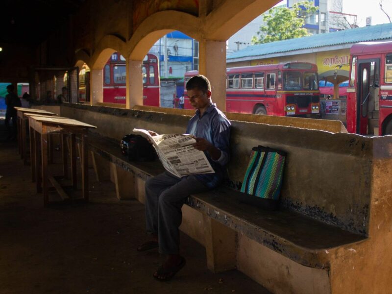 Image of a man reading a newspaper
