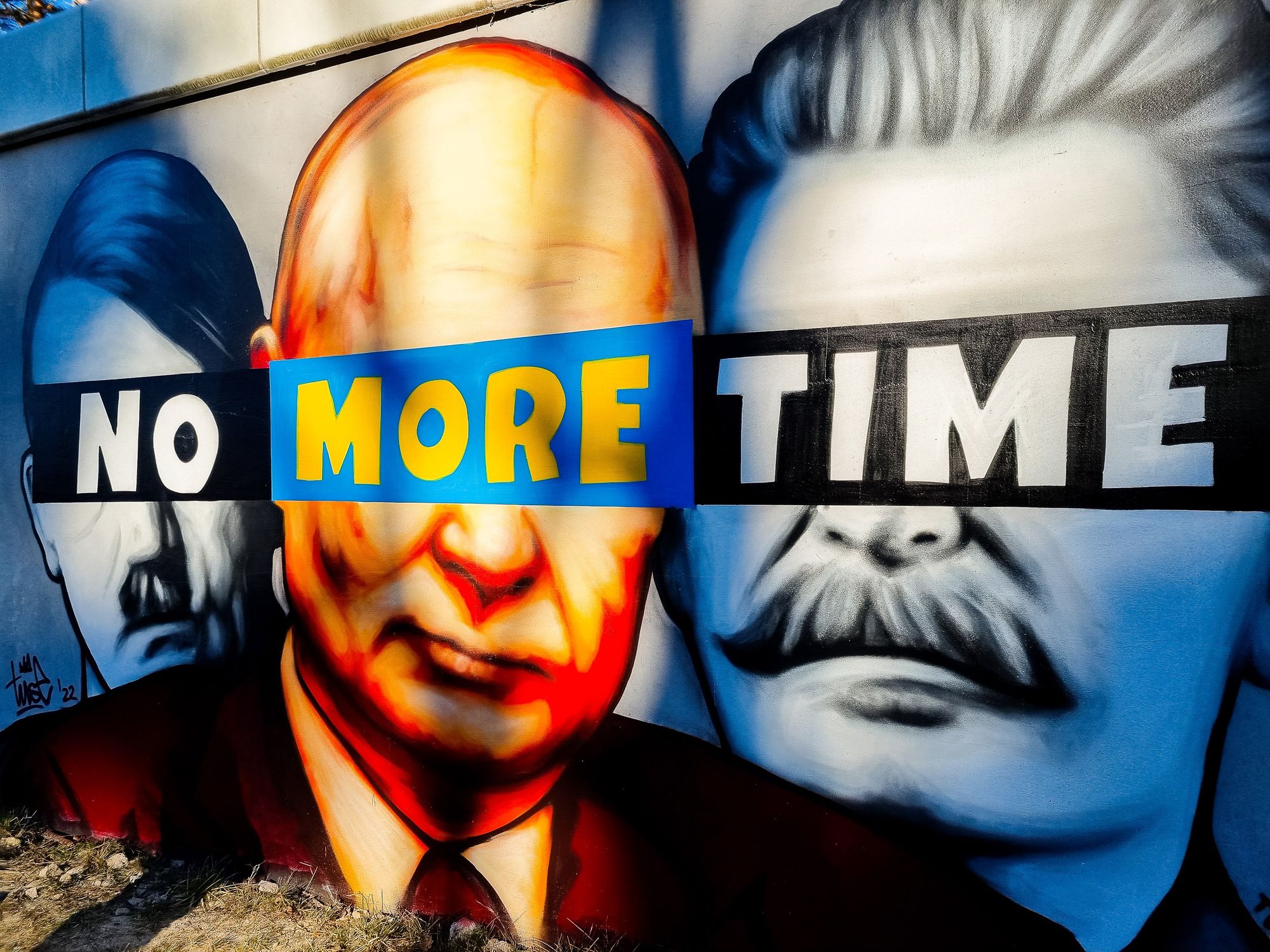 Image of A mural of Putin, Hitler, and Stalin with the slogan ''No More Time'' on the wall.