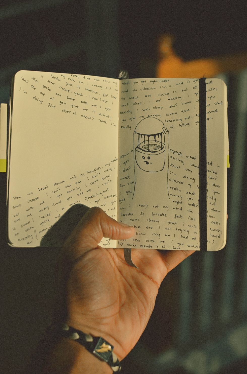 image of a person holding a notebook with mental health and psychology terms written in it