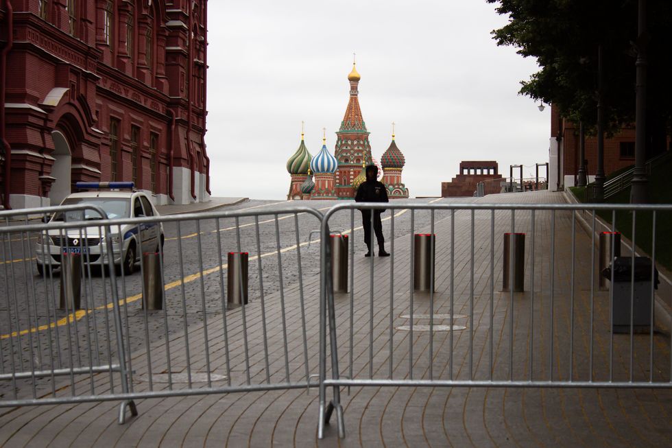 Image of a policeman standing on guard at the closed Red Square in Moscow.