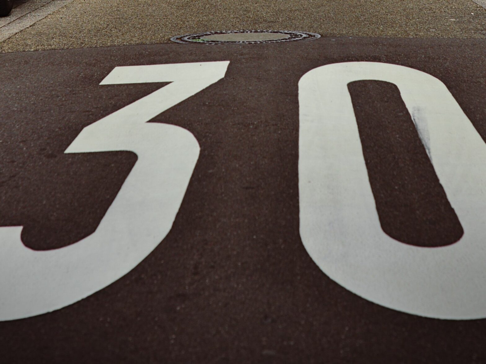 Image of a sign on a road indicating the speed limit.