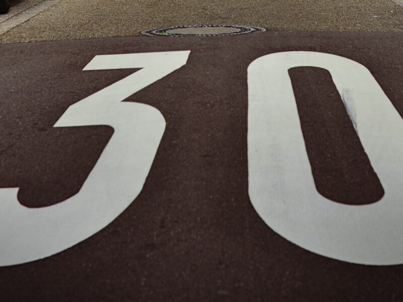 Image of a sign on a road indicating the speed limit.