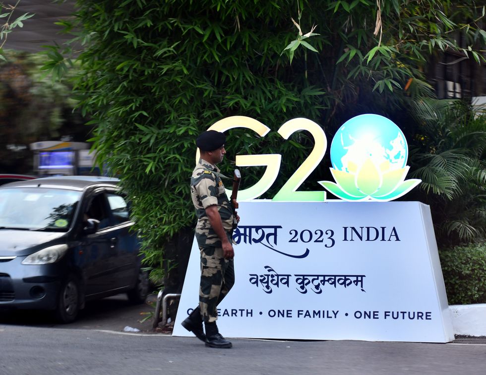 image of a soldier in front of a G20 sign in Delhi