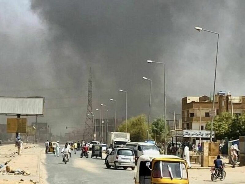 Image of a street with smoke in the sky in Khartoum, Sudan.