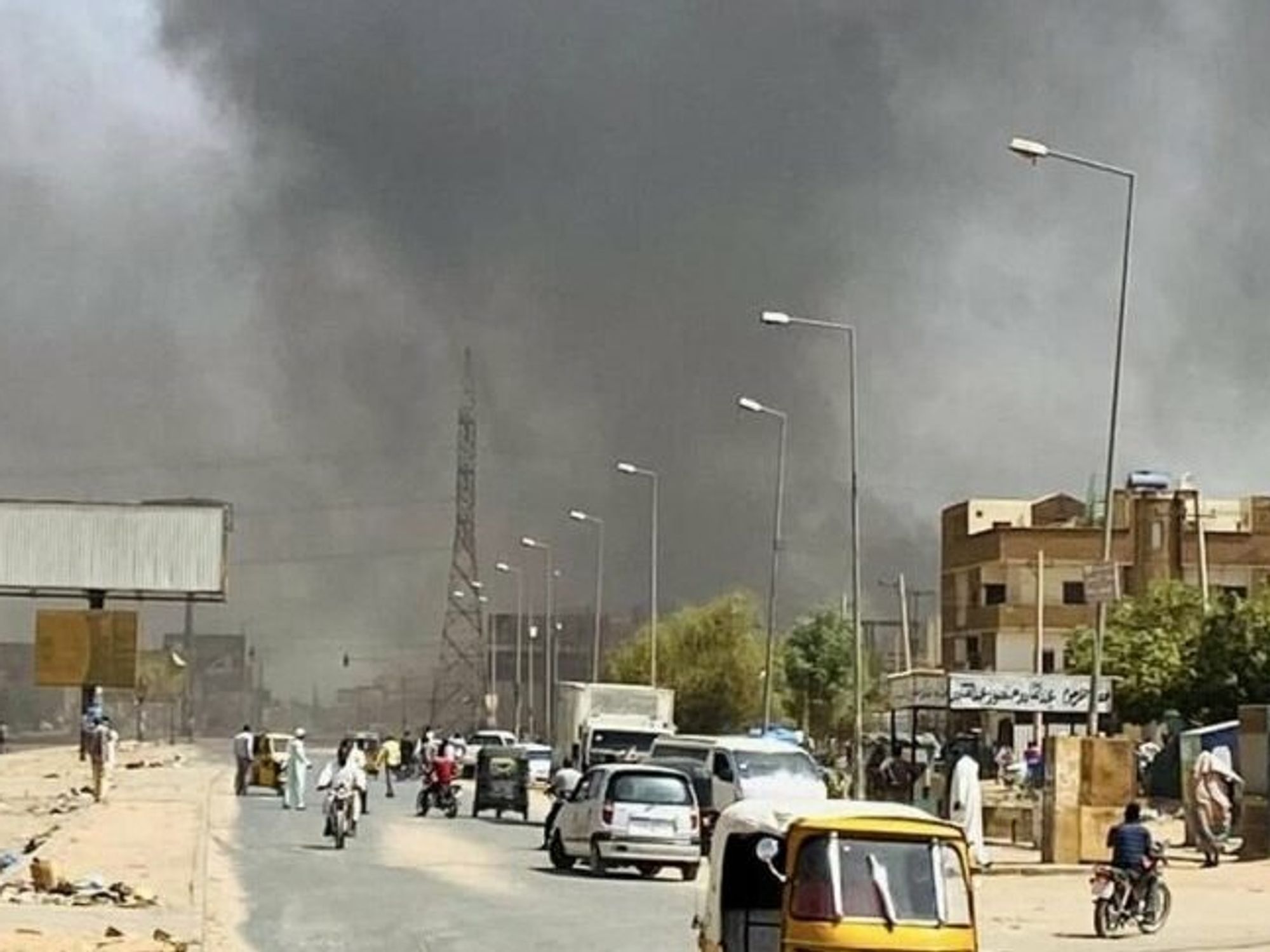 Image of a street with smoke in the sky in Khartoum, Sudan.