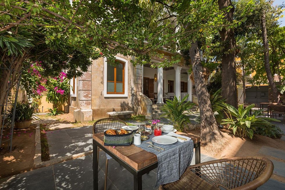 Image of a table with pastries in a courtyard