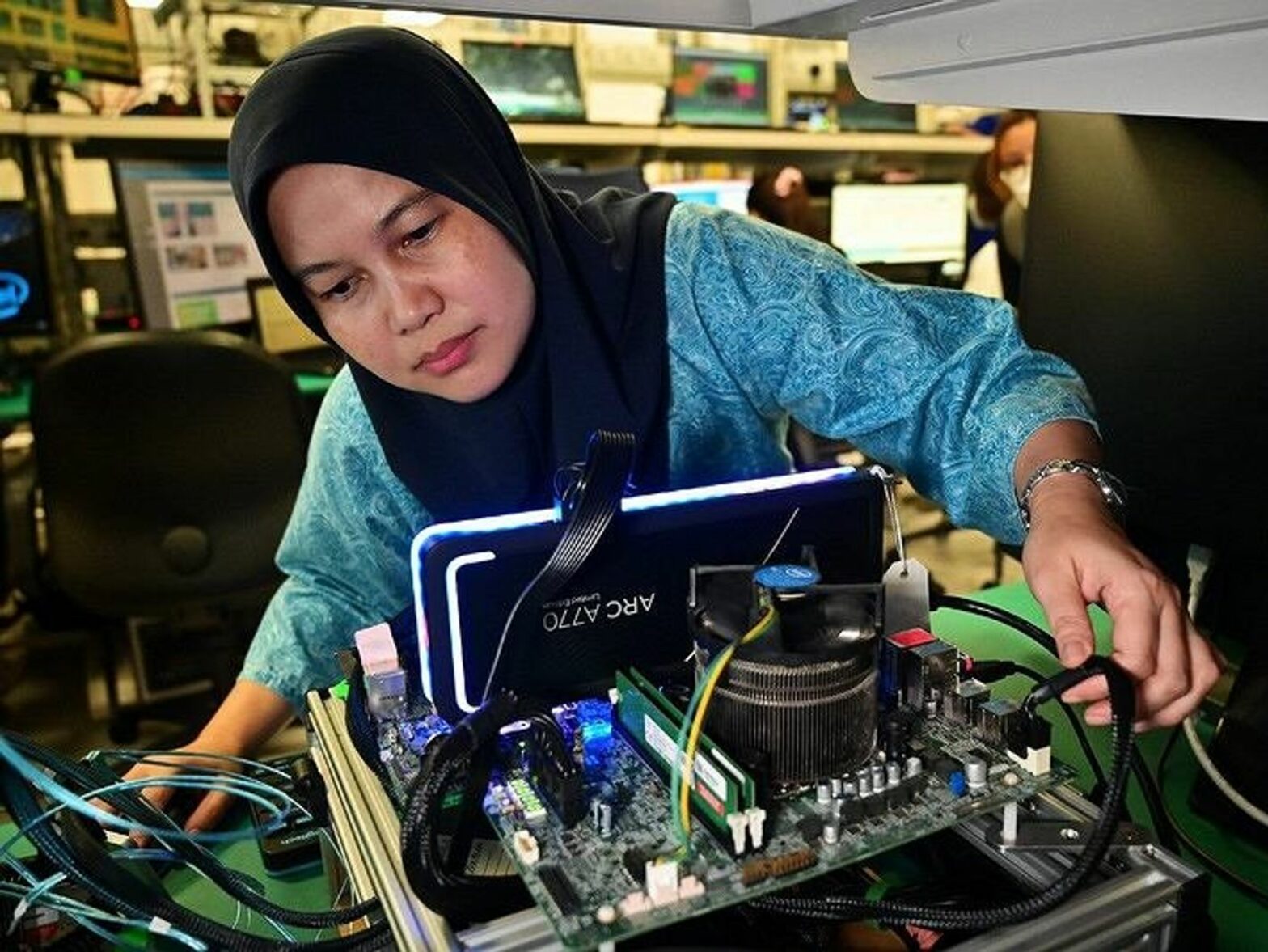 image of a woman fixing a computer