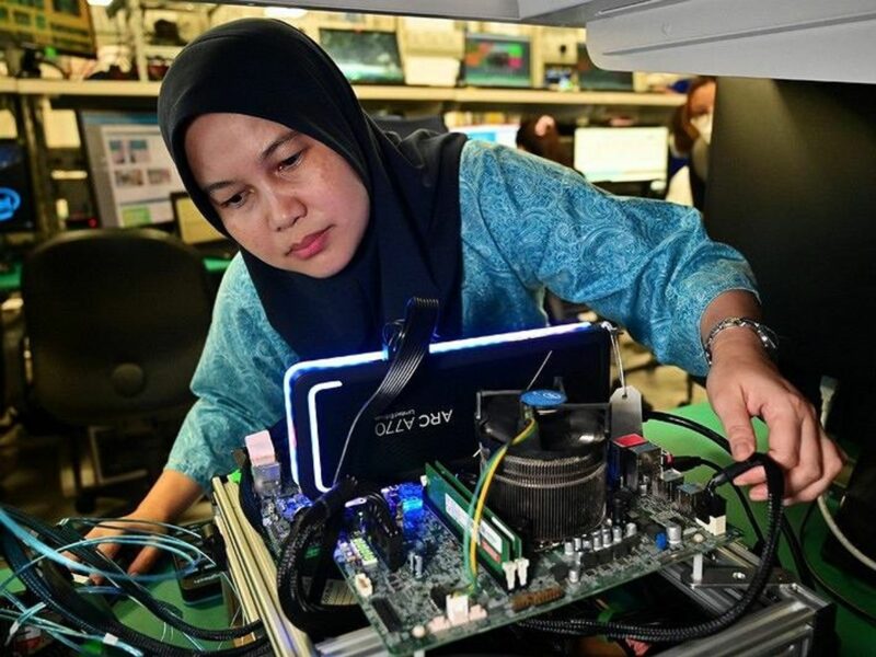 image of a woman fixing a computer
