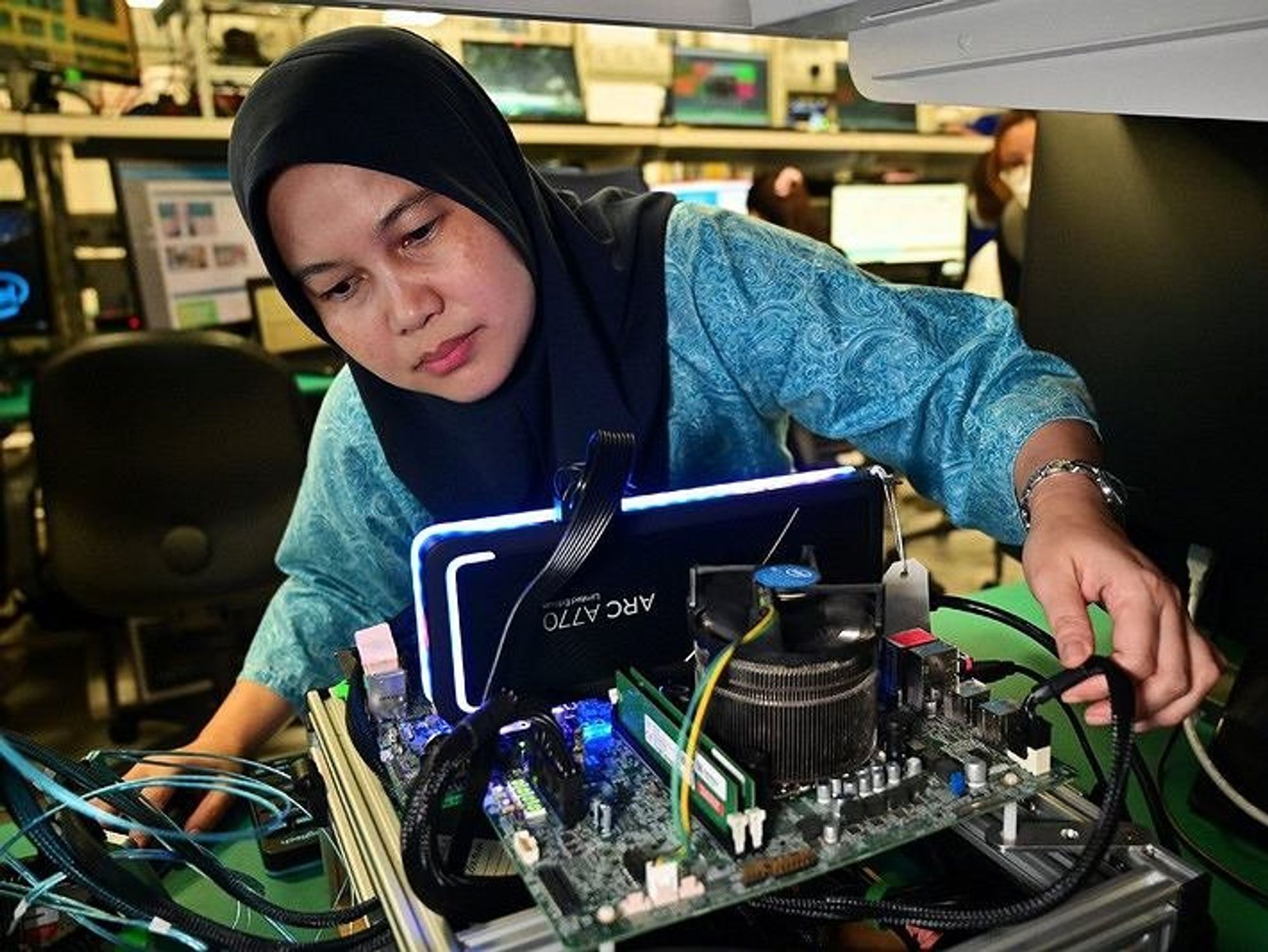 image of a woman fixing a computer