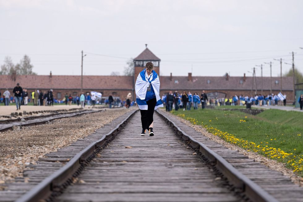 Image of a woman seen draped with the Israeli flag over her shoulders during the International March of The Living in Oswiecim, Poland.