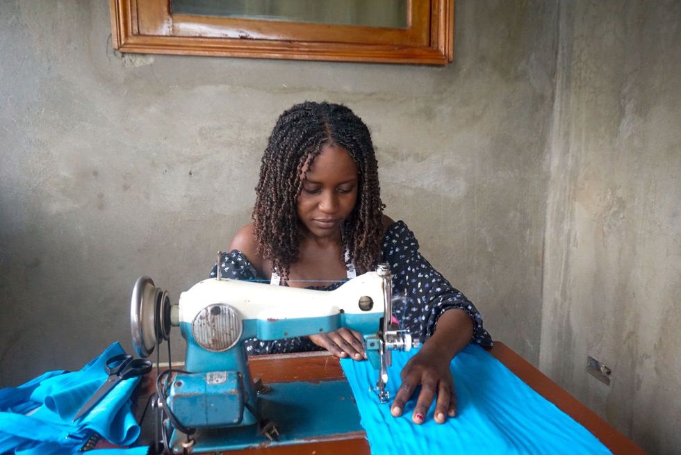 Image of a woman sewing clothes