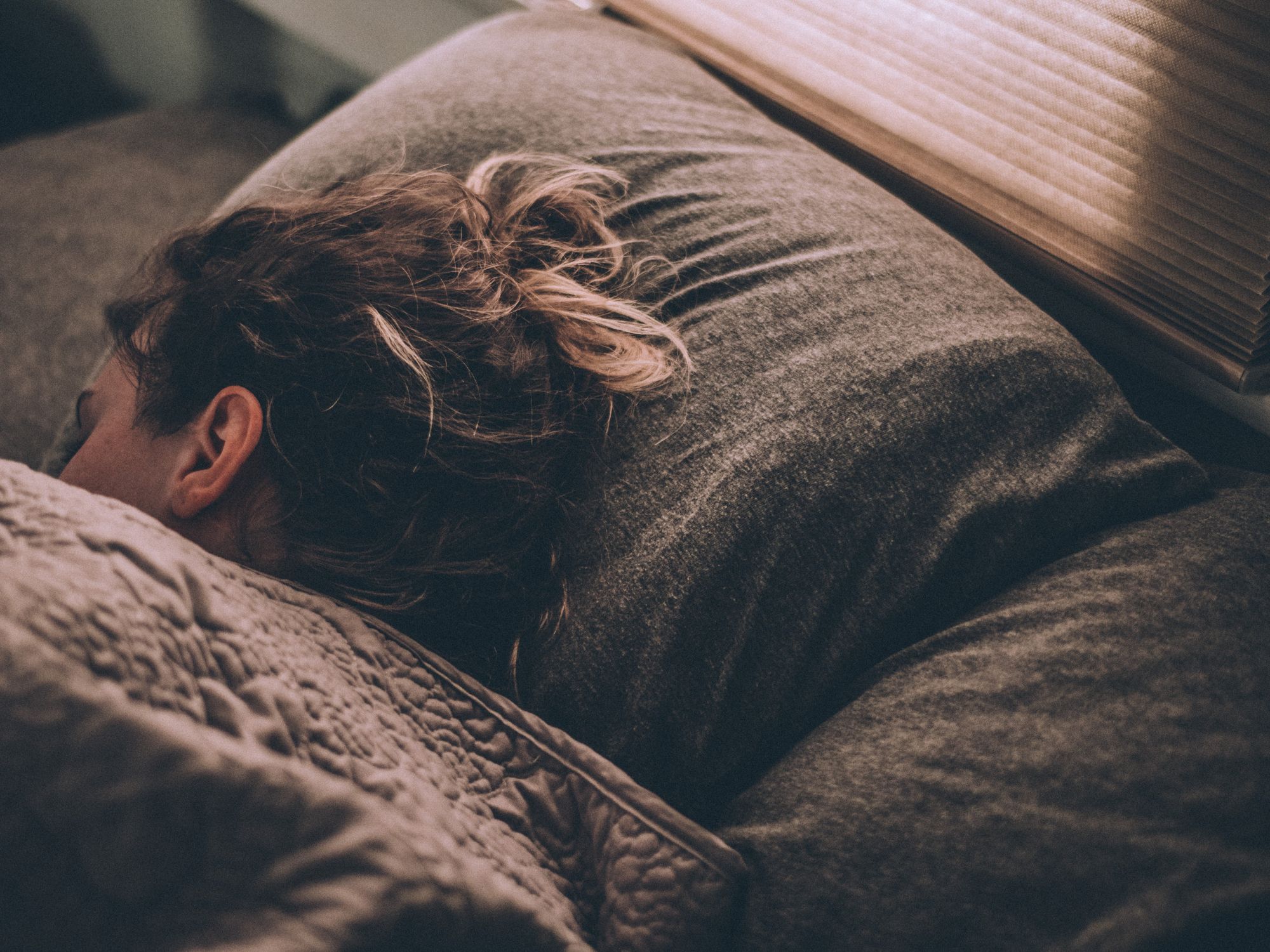 Image of a woman sleeping in a bed.