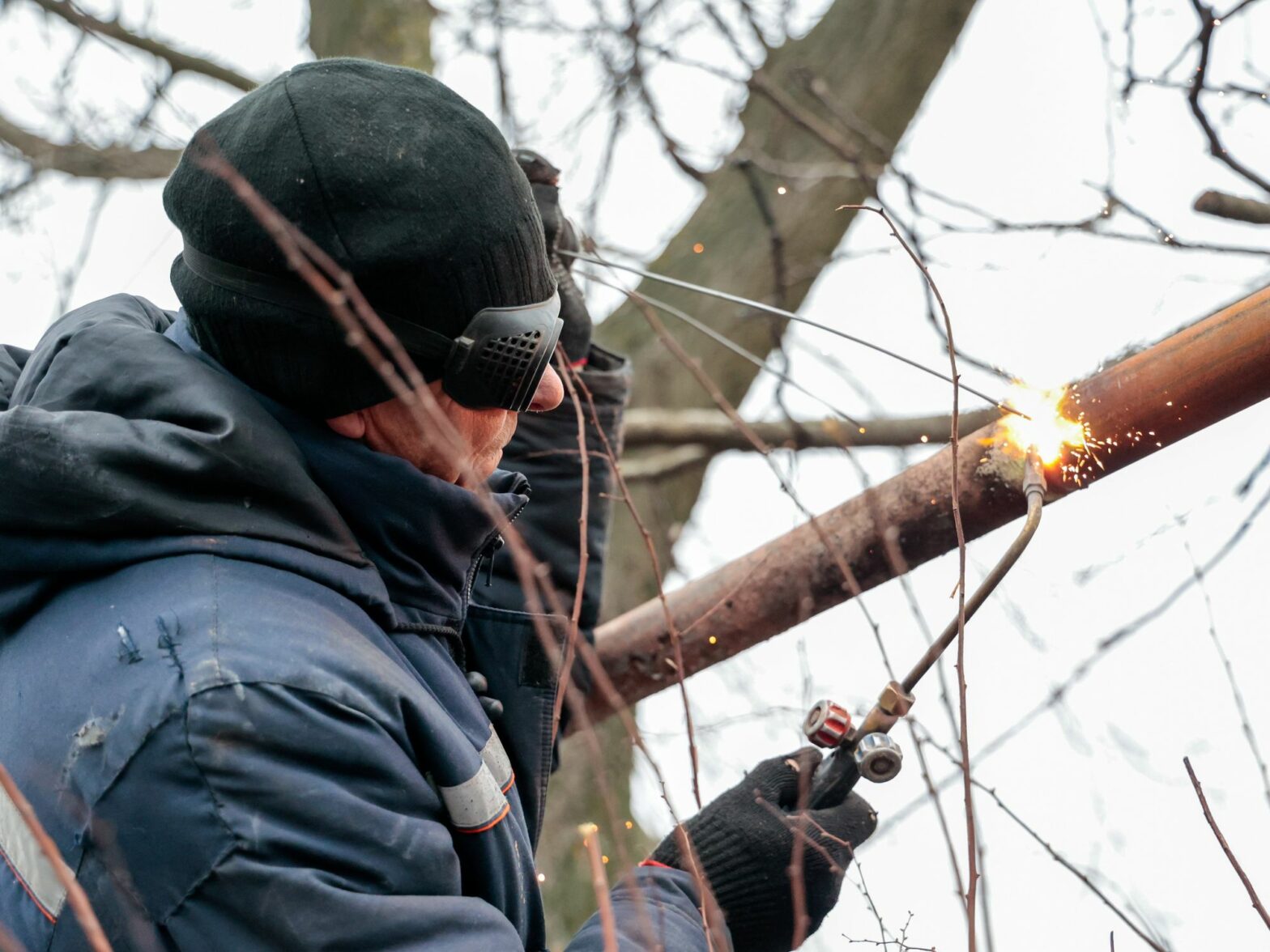 Image of a worker repairing a gas pipeline damaged by a Ukrainian military strike on the centre of the town of Volnovakha, Russia
