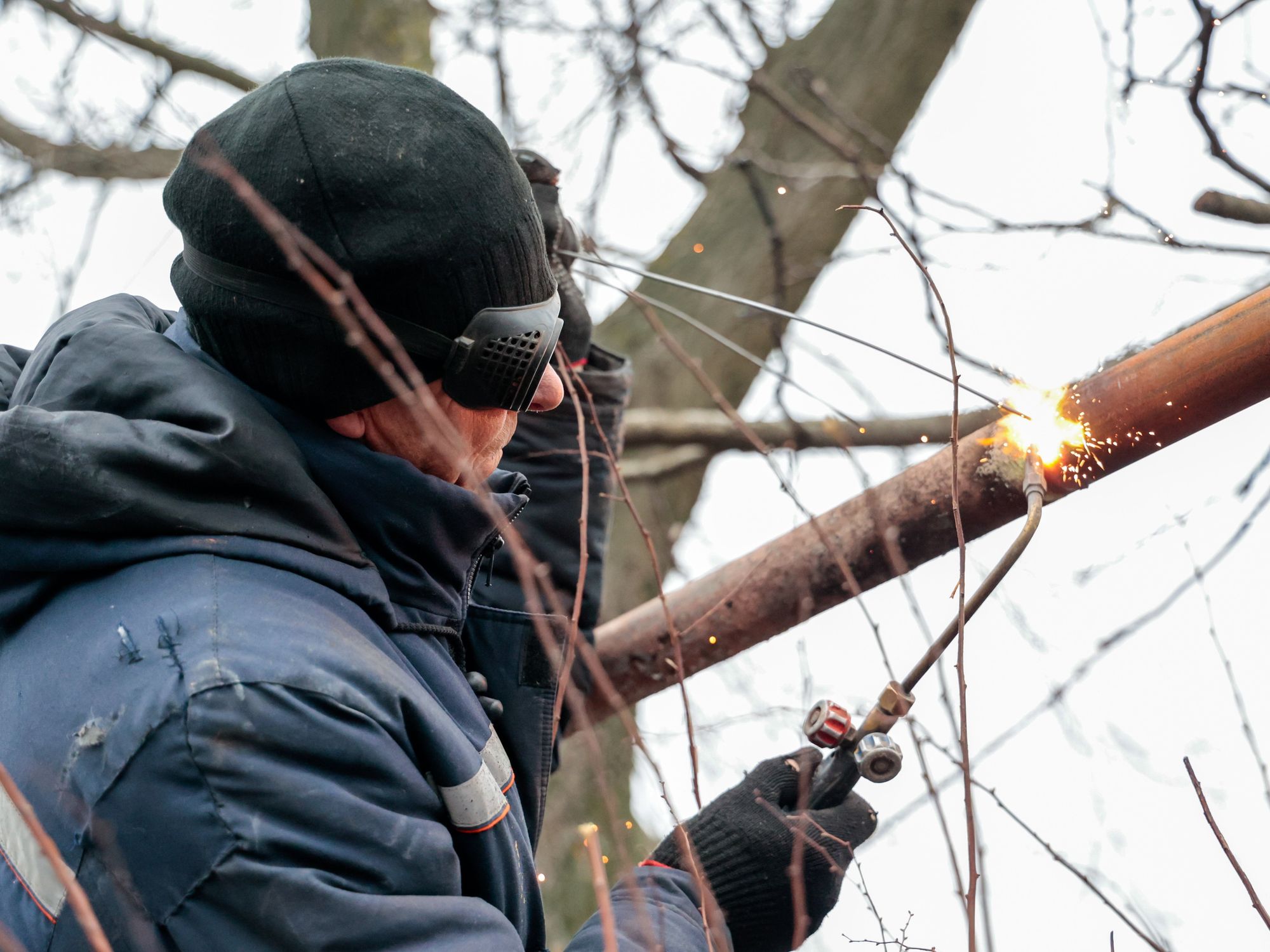 Image of a worker repairing a gas pipeline damaged by a Ukrainian military strike on the centre of the town of Volnovakha, Russia