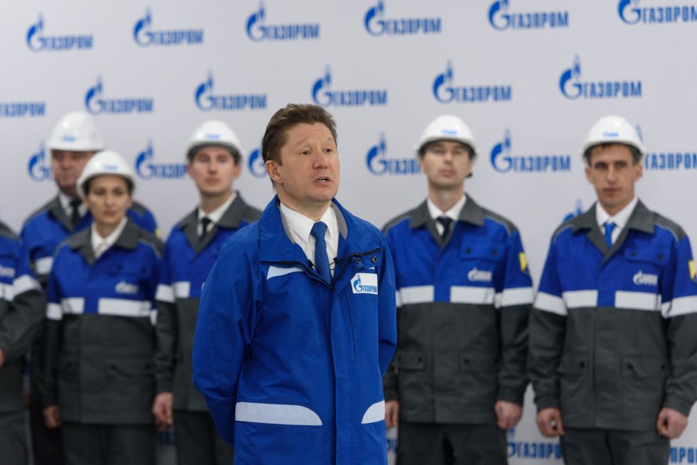 Image of Alexey Miller (front), head of Russian gas giant Gazprom, and staff members at the launching ceremony of the China-Russia east-route natural gas pipeline at a gas-distributing and compressing station in Amur region, Russia.