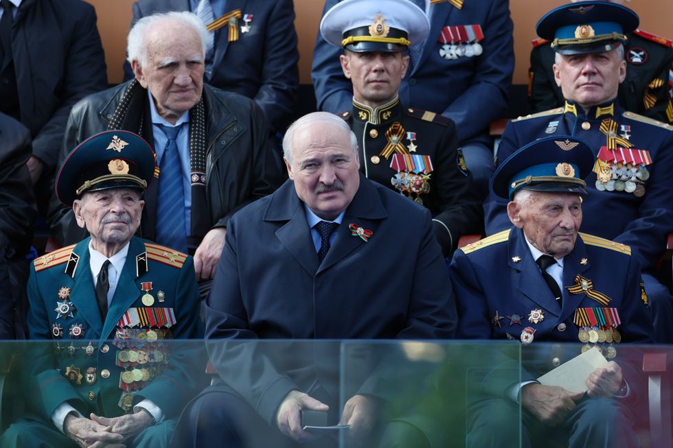 Image of Belarus' President Alexander Lukashenko (C) attending a Victory Day military parade in Red Square, Moscow.