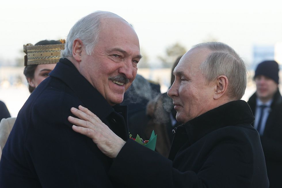 Image of Belarusian President Alexander Lukashenko welcoming Russian President Vladimir Putin in his arms.
