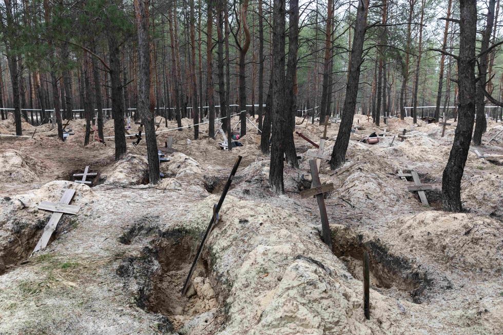 Image of crosses at a forest grave un Izium, Ukraine.