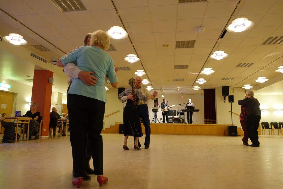 Image of ​seniors dancing in a retirement home.