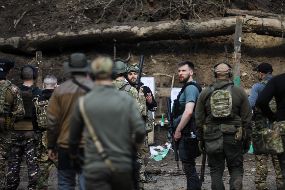 Image of ​Volunteers on a break during a military training program in Kyiv, Ukraine.