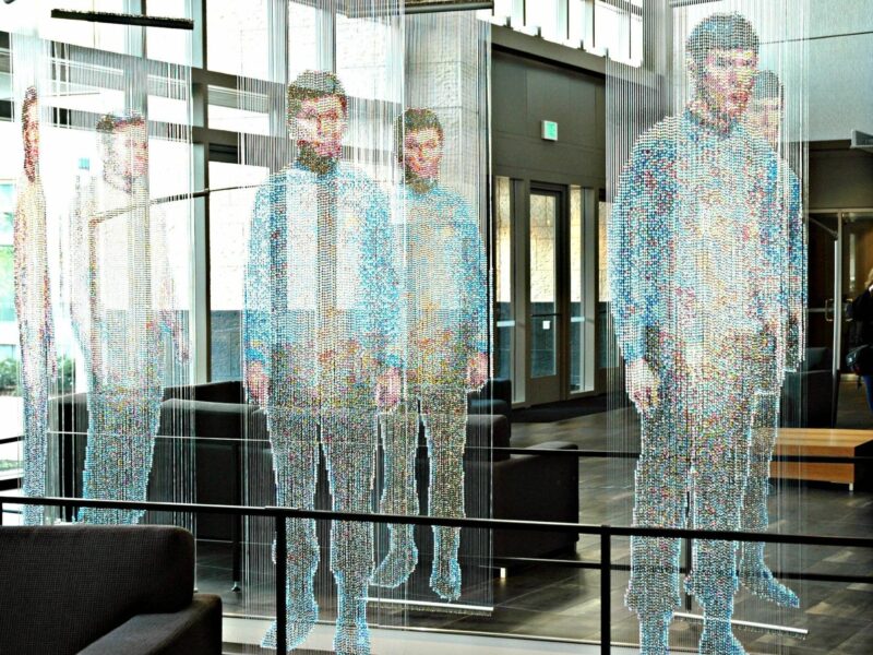 Image of holographic bodies standing next to each other in an office