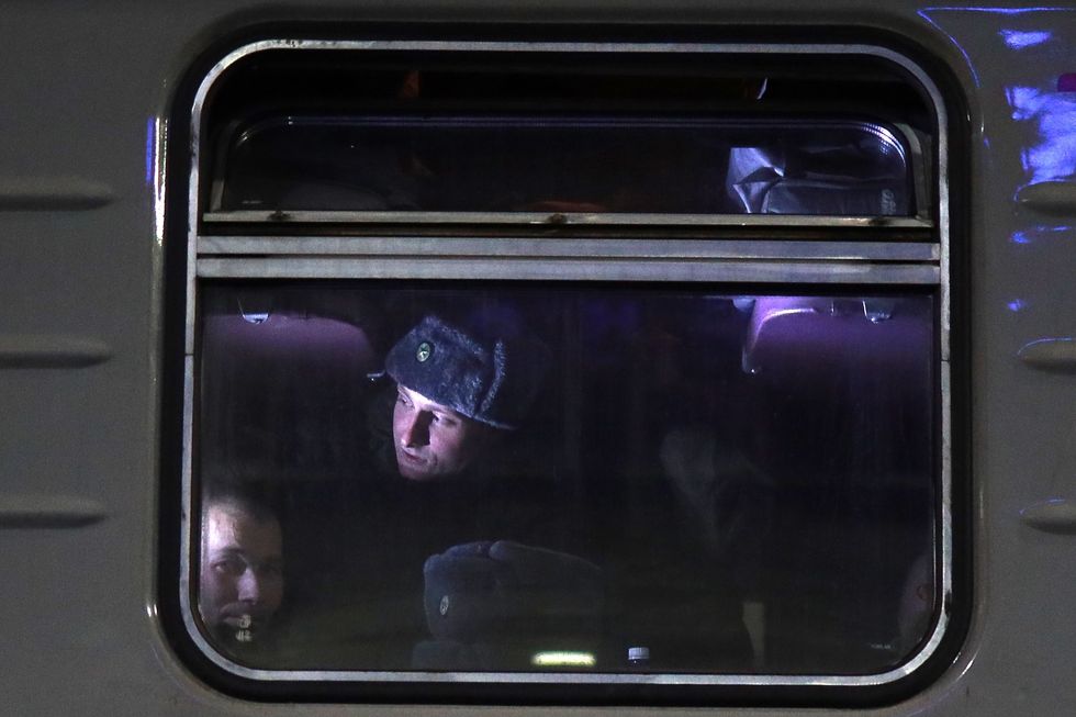 Image of Mobilized servicemen are seen on a train at a railway station ahead of departing for the zone of Russia's special military operation.