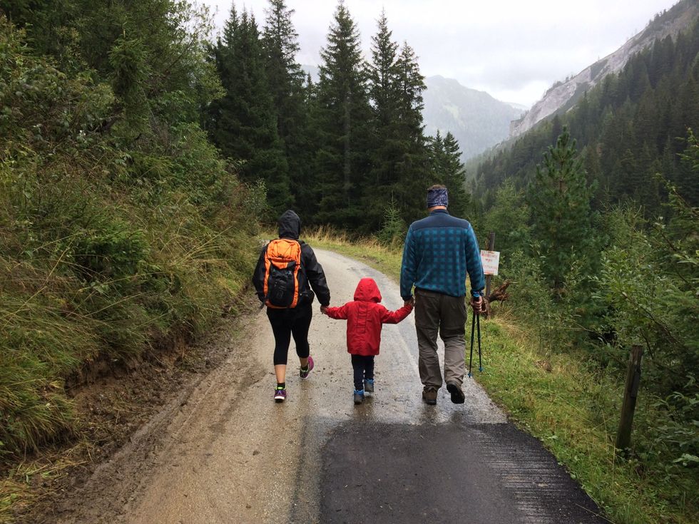Image of parents with their kid hiking.