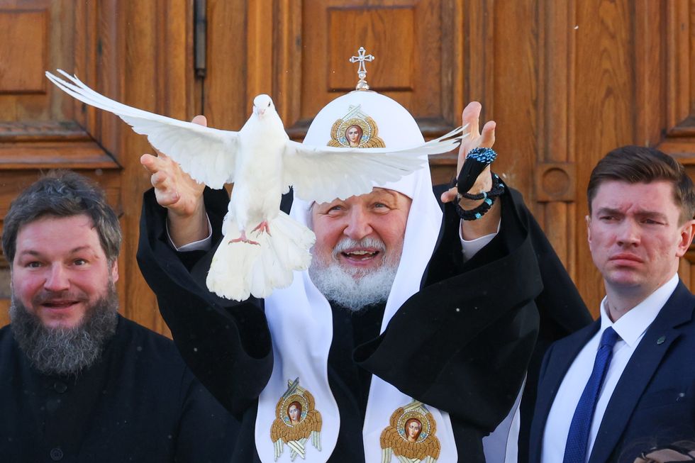 Image of Patriarch Kirill (C) of Moscow and all Russia releasing a dove into the sky to mark the feast of Annunciation outside the Annunciation Cathedral of the Moscow Kremlin