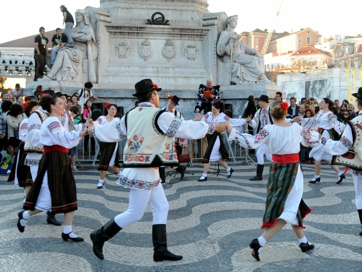 Image of people dancing, holding hands, in Lisbon, Portugal.