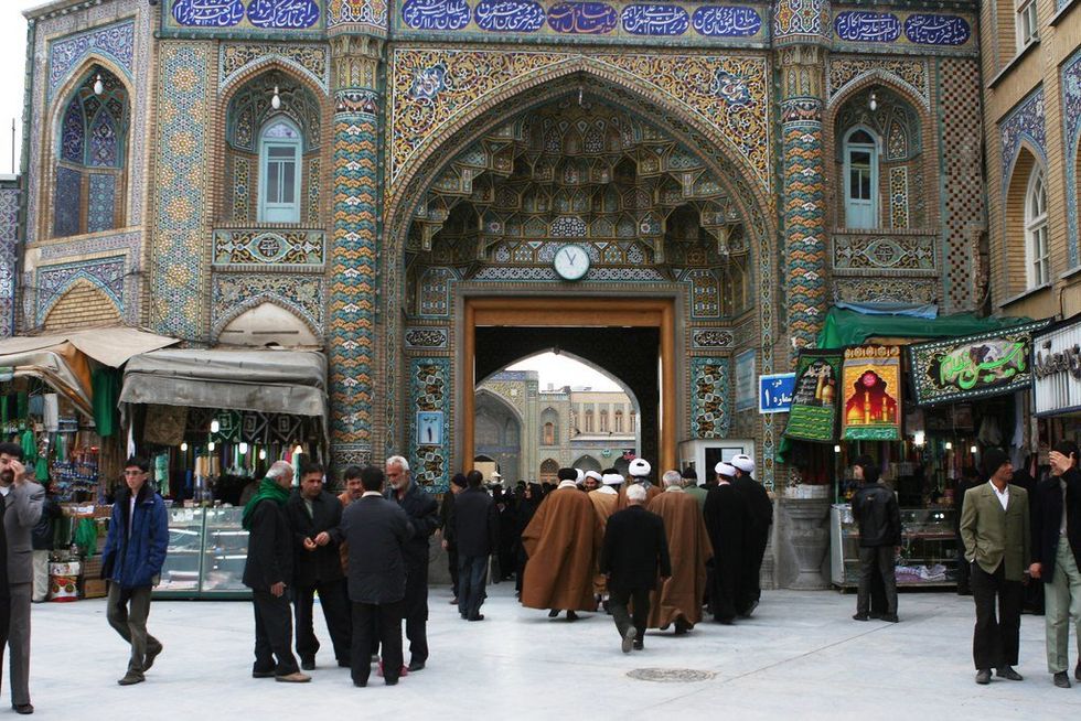 Image of people walking in a street in the city of Qom, Iran.