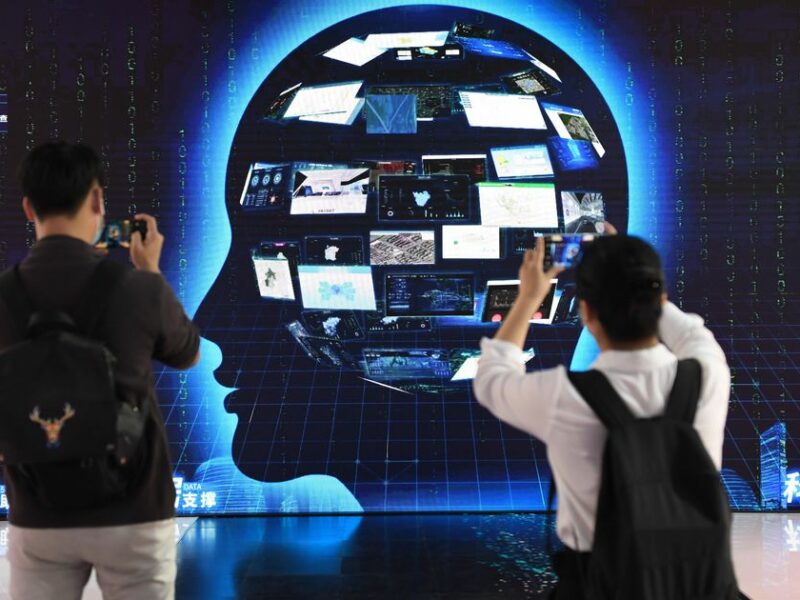 Image of people watching an exhibit at the 23rd China Beijing International High-tech Expo in Beijing, China.